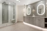 Expansive primary bathroom featuring a contemporary design that combines elegance and functionality.